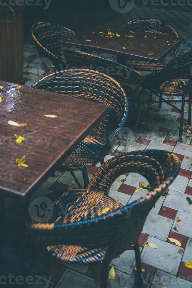 wooden table with wicker chairs in a summer cafe in autumn photo