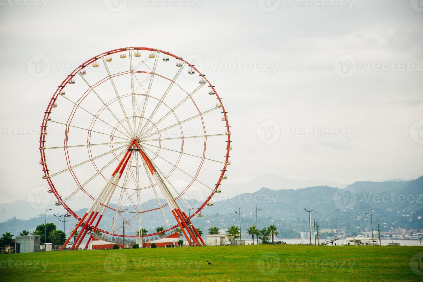 Ferris wheel on embankment of Batumi at sunny day.... photo