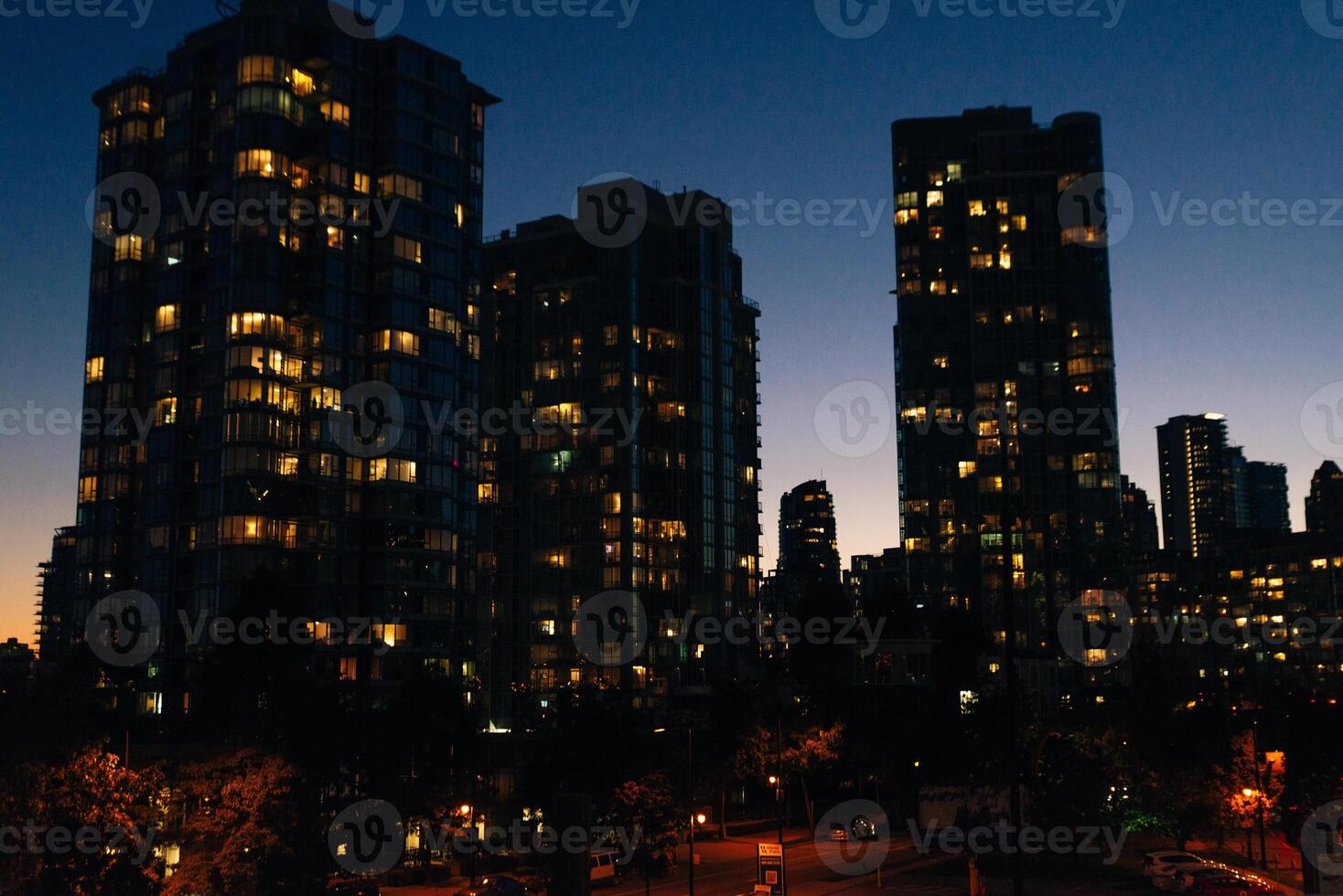 buildings illuminated in the city on coastline at Vancouver, Canada. photo