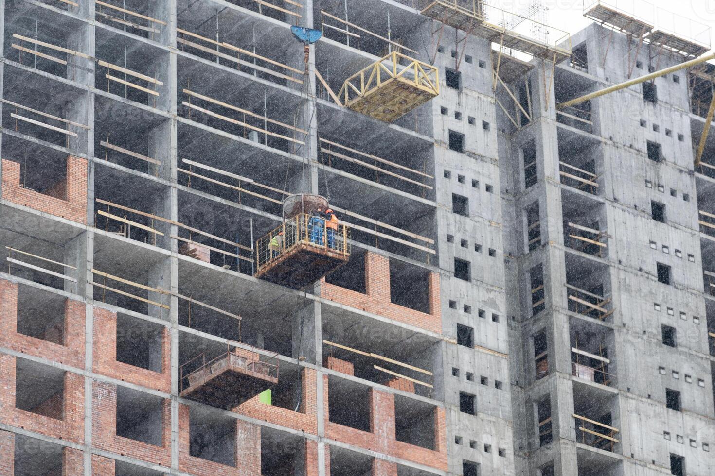 Construction site background. Hoisting cranes and new multi-storey buildings. Industrial background. photo