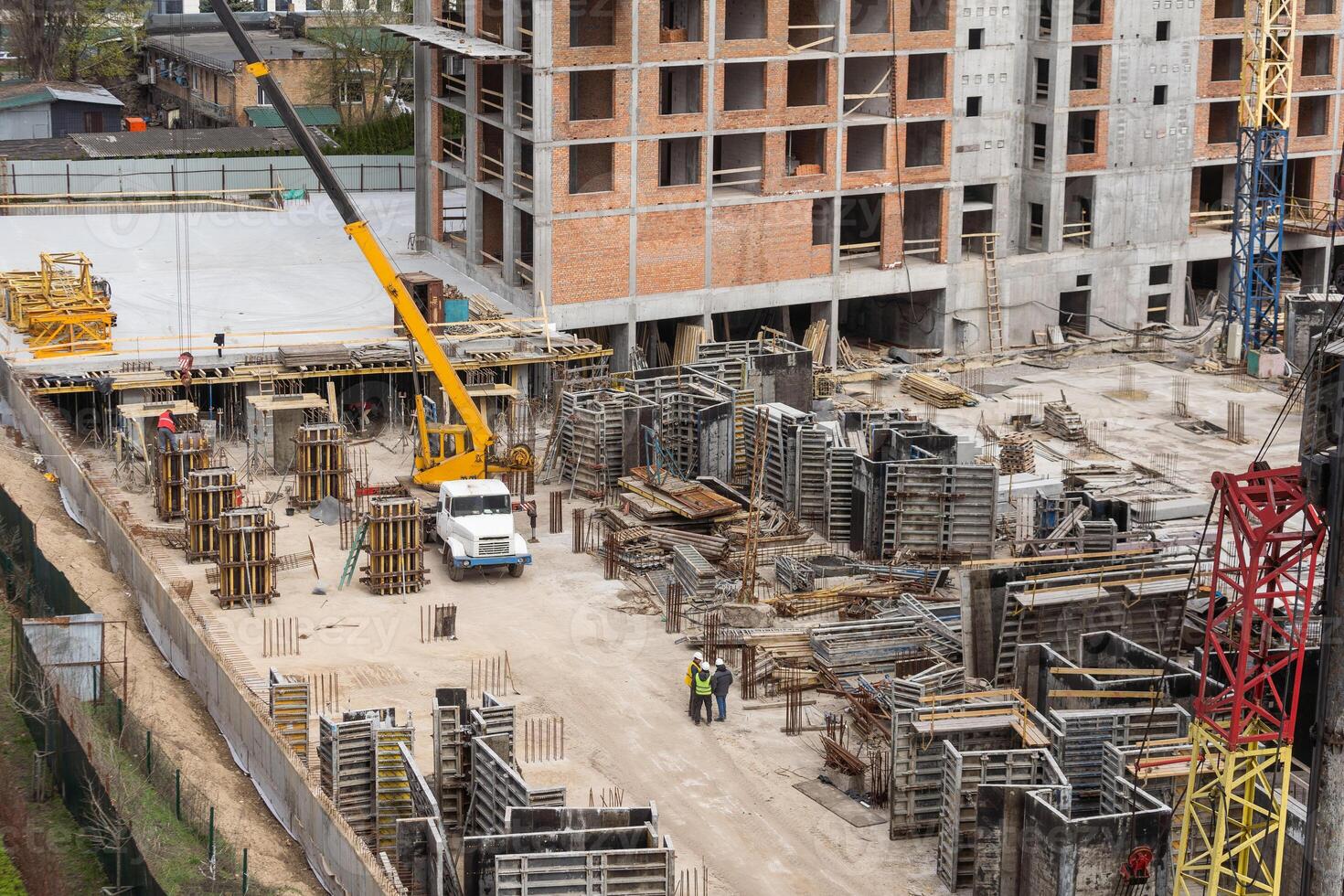 Construction site with crane and scaffold photo