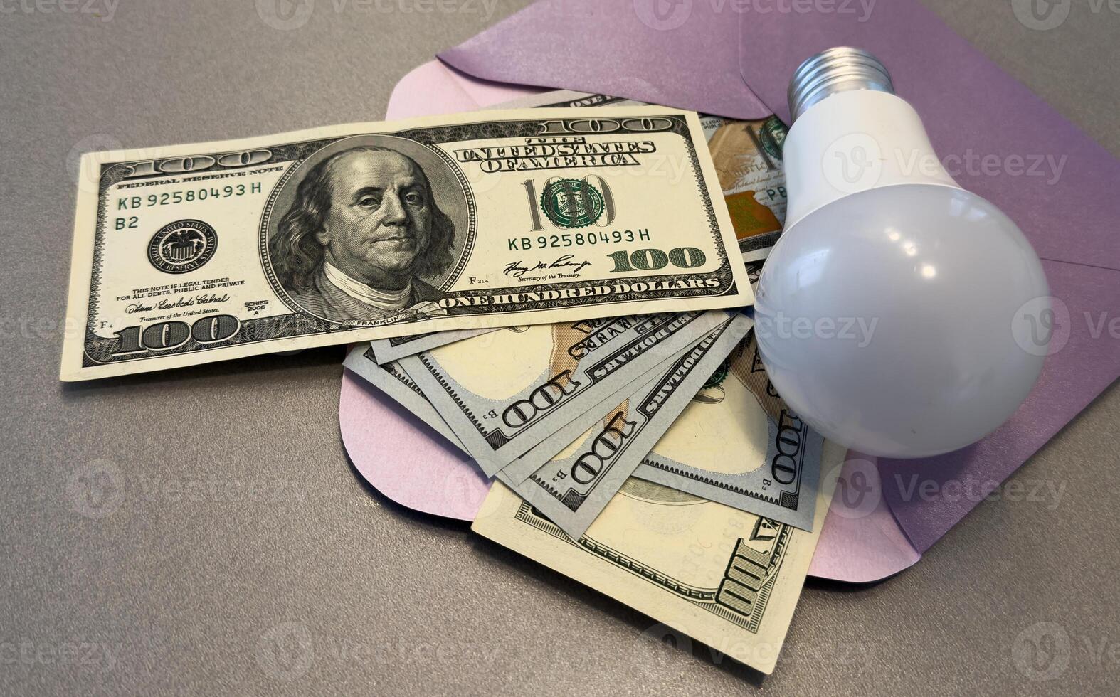 Energy saving light bulbs with american currency , dollars on a background. Payment for electricity, financial condition of the energy market, increase in energy prices. photo