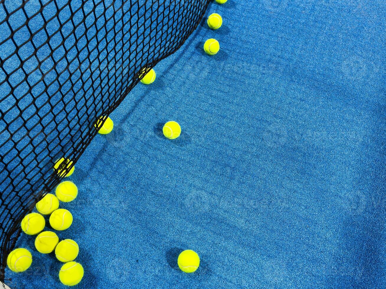 paddle tennis ball next to the net of a paddle tennis court. photo