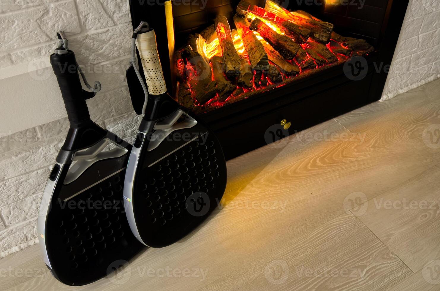 padel rackets by the fireplace photo
