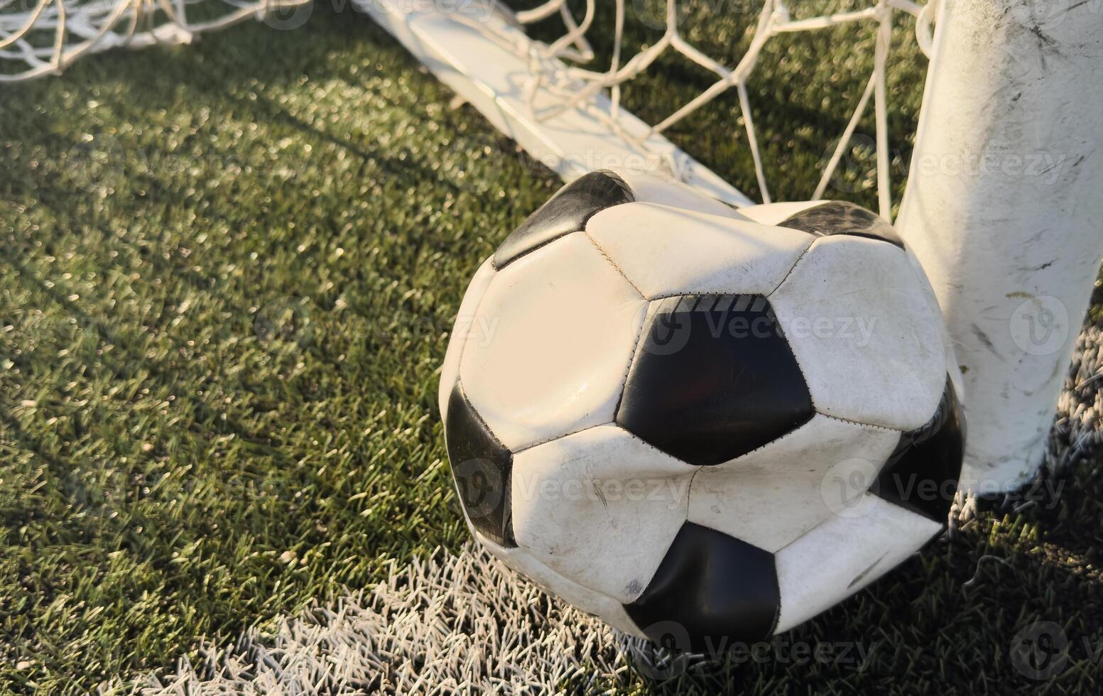 Deflated soccer ball on grass. Soccer concept. photo