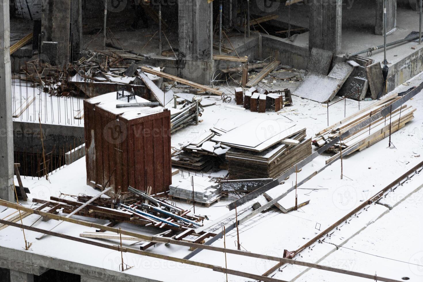 concreting work. construction site worker during concrete pouring into formwork at building area with skip photo