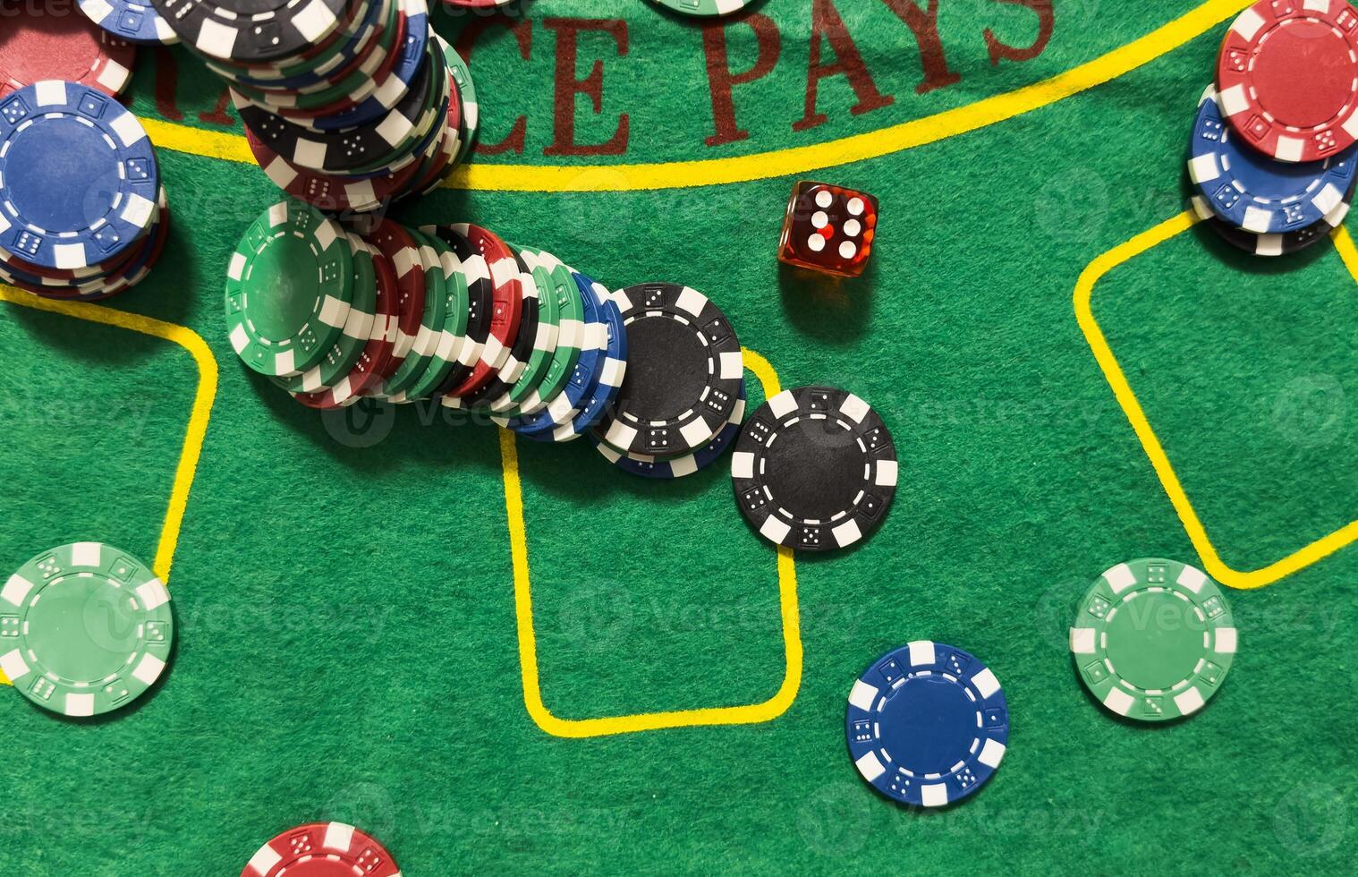 Rolling red dice on a casino table with chips photo