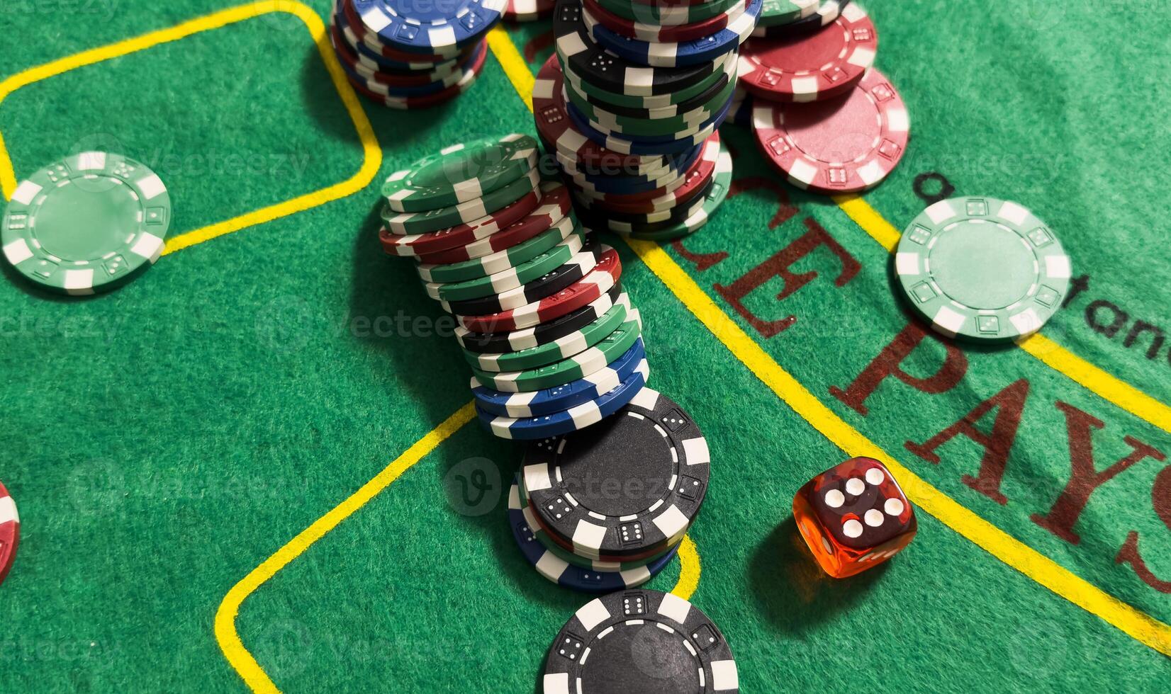 Rolling red dice on a casino table with chips photo