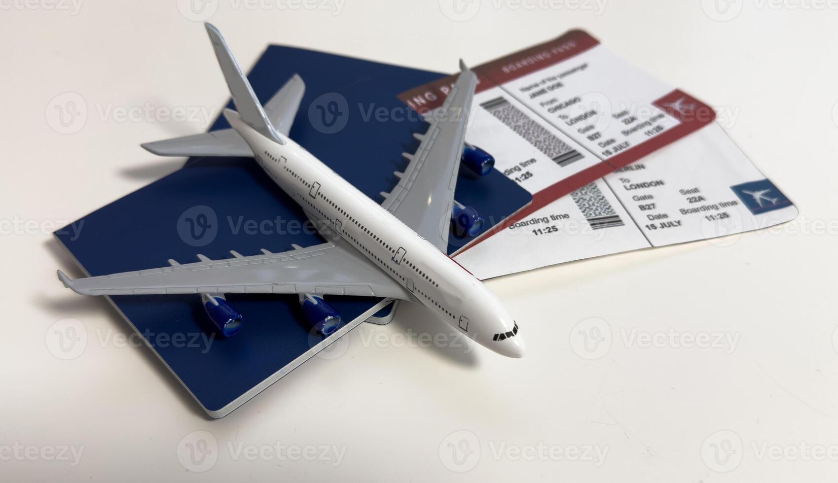 Toy airplane and passport with tickets on gray background, top view photo