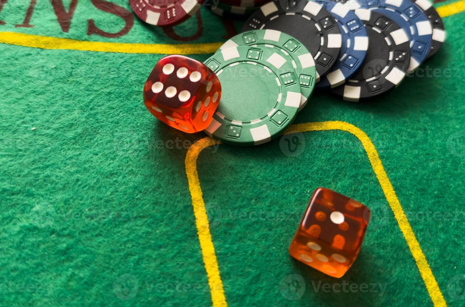 Rolling red dice on a casino table with chips photo