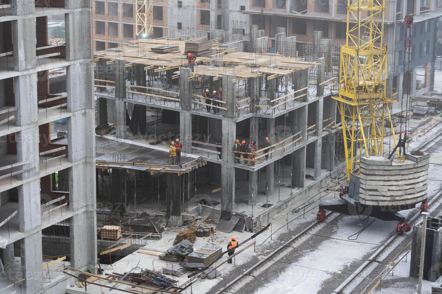 Group of construction engineer team in standard safety uniform work planing in construction site photo