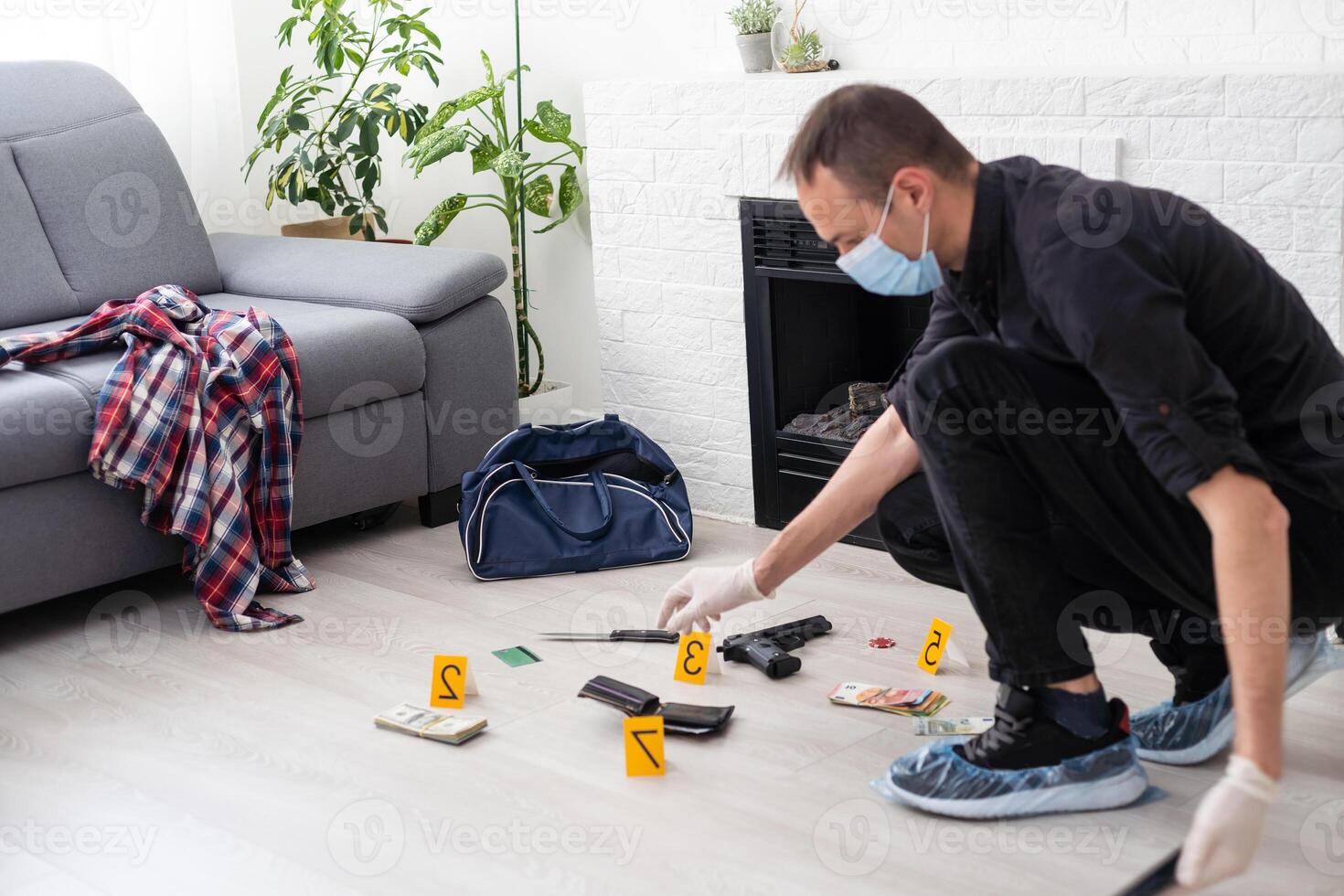 Criminological expert collecting evidence at the crime scene. photo