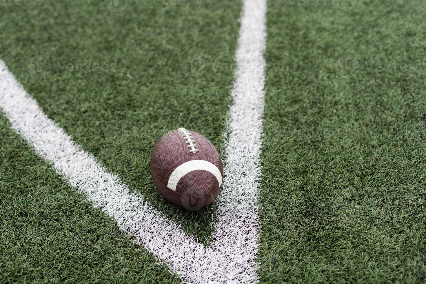 Football on Yardage Marker. Low Angle. Horizontal View photo