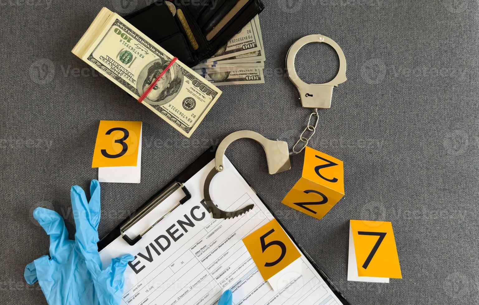 Crime scene, physical evidence. Gun handcuffs, money, dollar on a dark background. photo