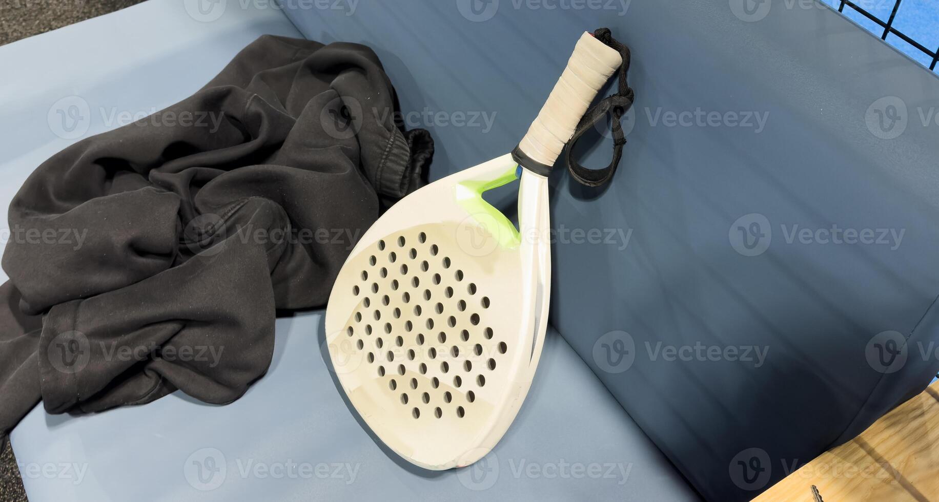 padel racket on a padel court with a ball photo