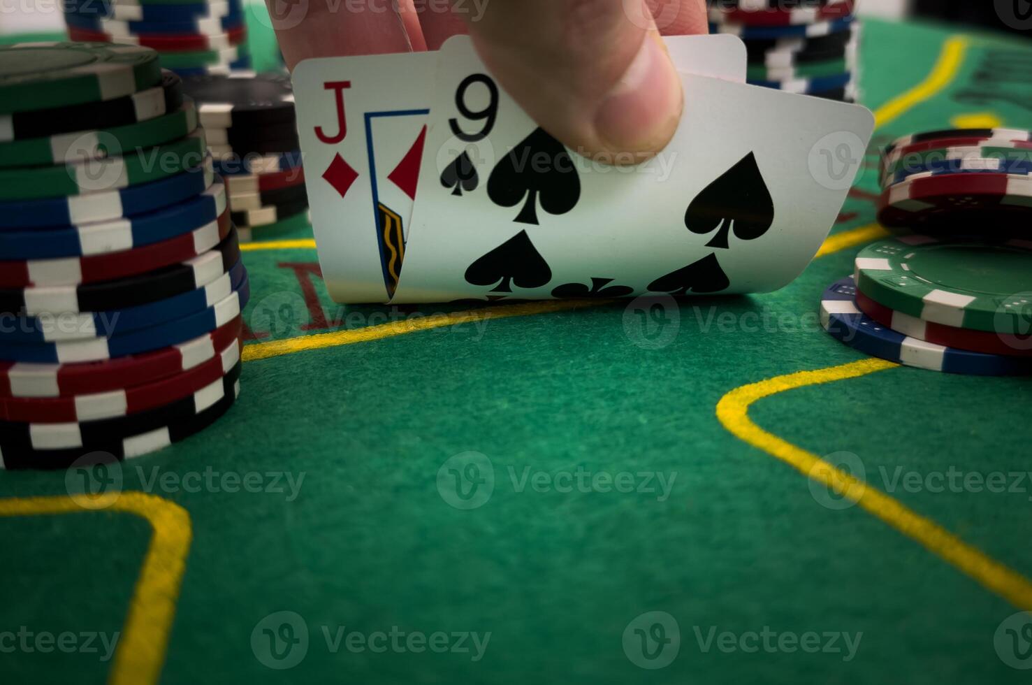 Close Up Shot On Hand Of Anonymous Poker Player Checking Playing Cards He Was Dealt. Professional High Stakes Gambler Making A Bet, Thinking Of Strategy, Counting Chips In Competitive Tournament. photo