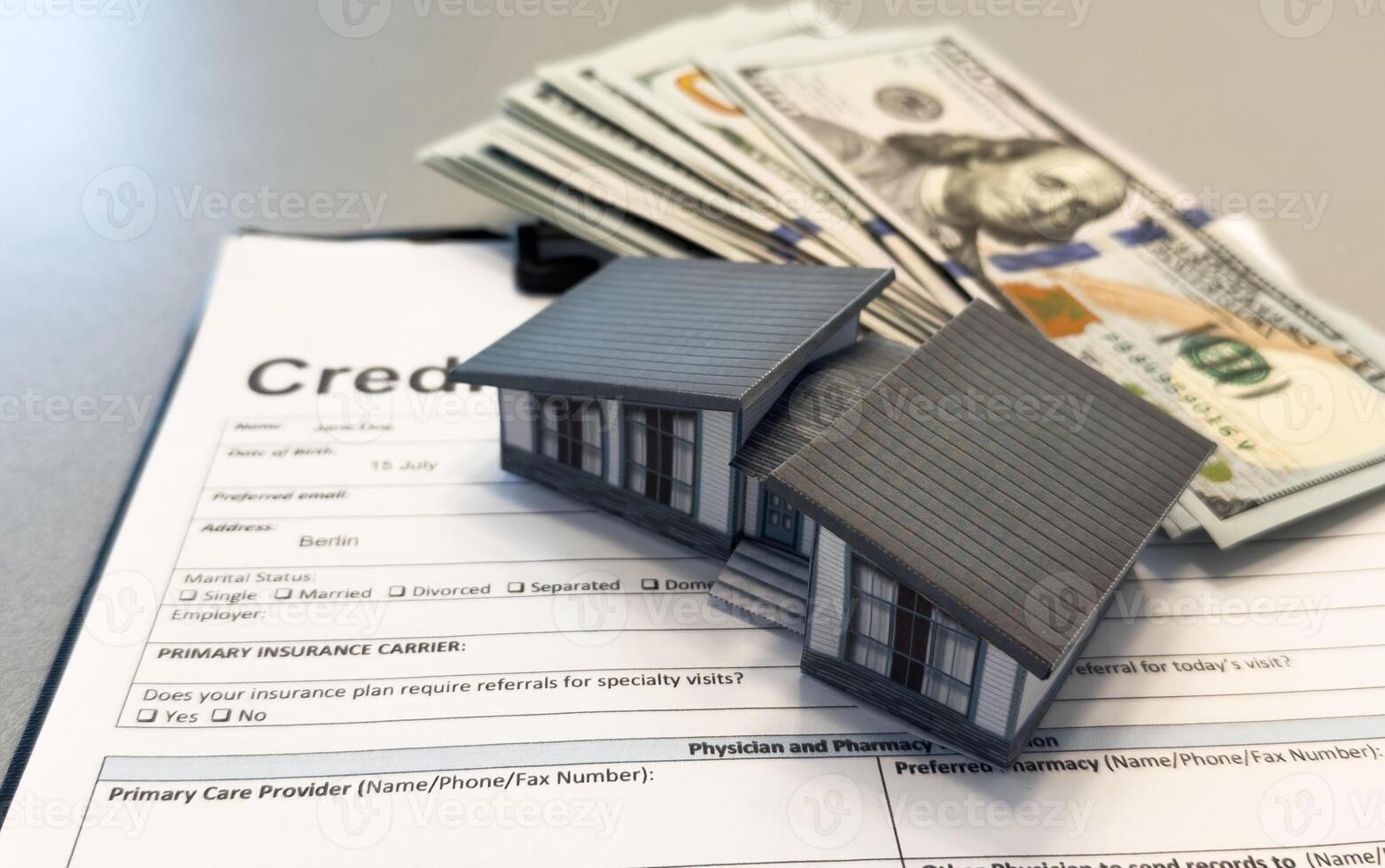 Business loan concept. Maniature house and pile of hundred dollar bills. photo