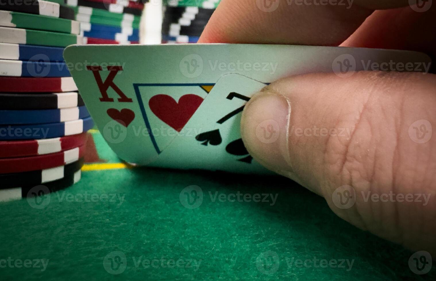professional poker game. Green poker table with two games. poker player folds by throwing cards on the table photo