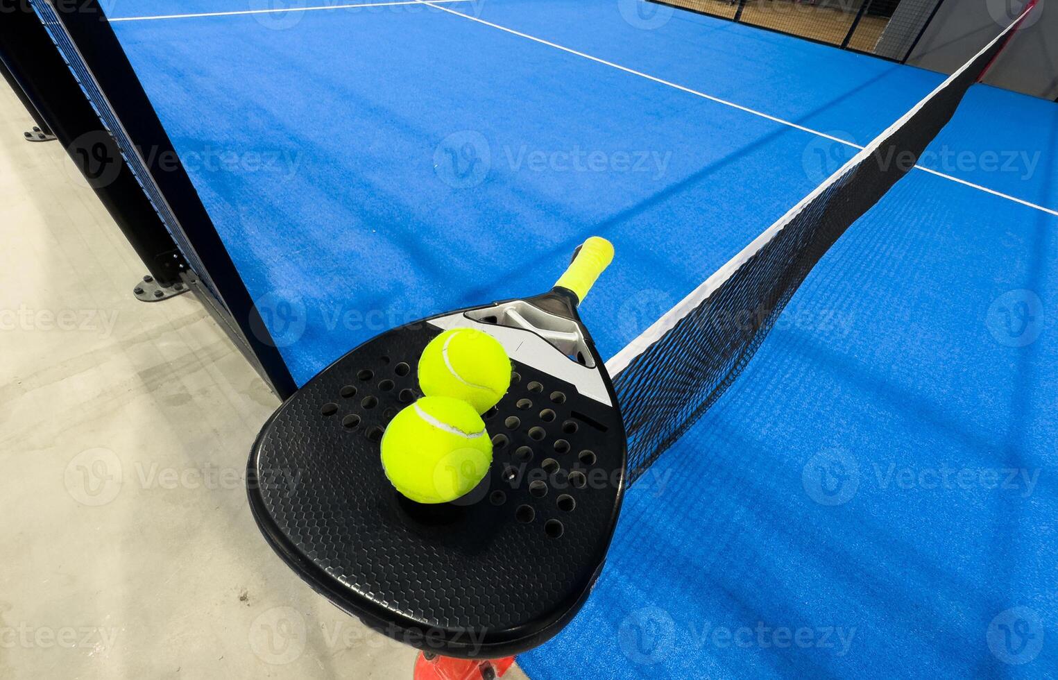 padel racket on a padel court with a ball photo