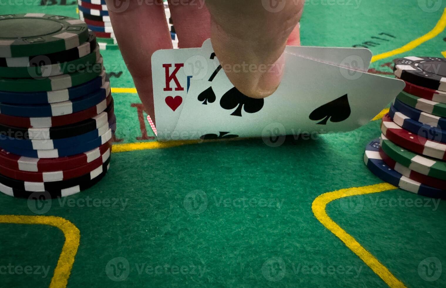 professional poker game. Green poker table with two games. poker player folds by throwing cards on the table photo