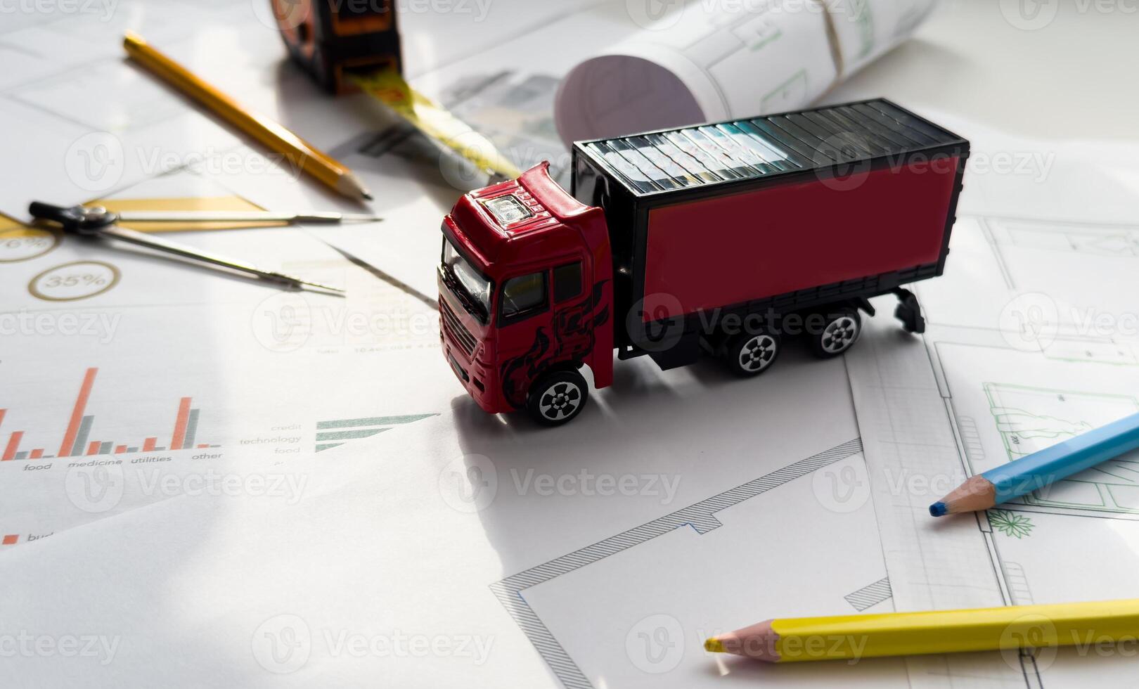 Close up of small replica of a truck on blueprint and engineer hands sketching a construction architectural project. photo