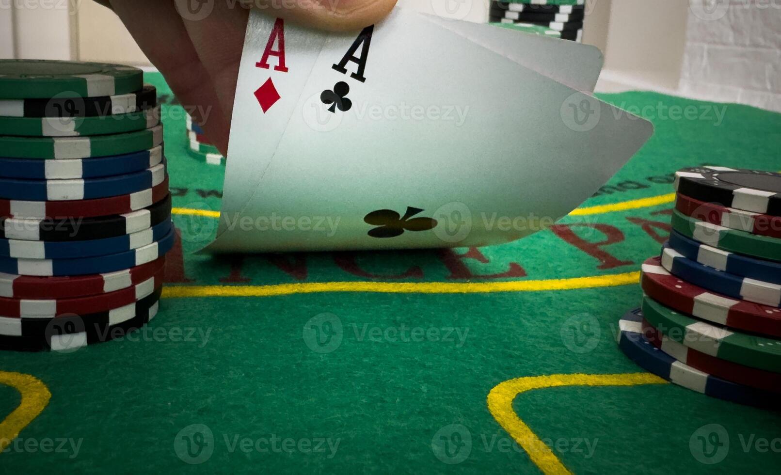 professional poker game. Green poker table with two games. poker player folds by throwing cards on the table photo