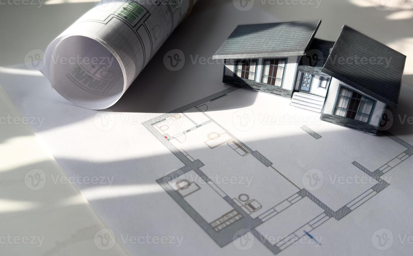 building house on blueprints with worker construction project photo