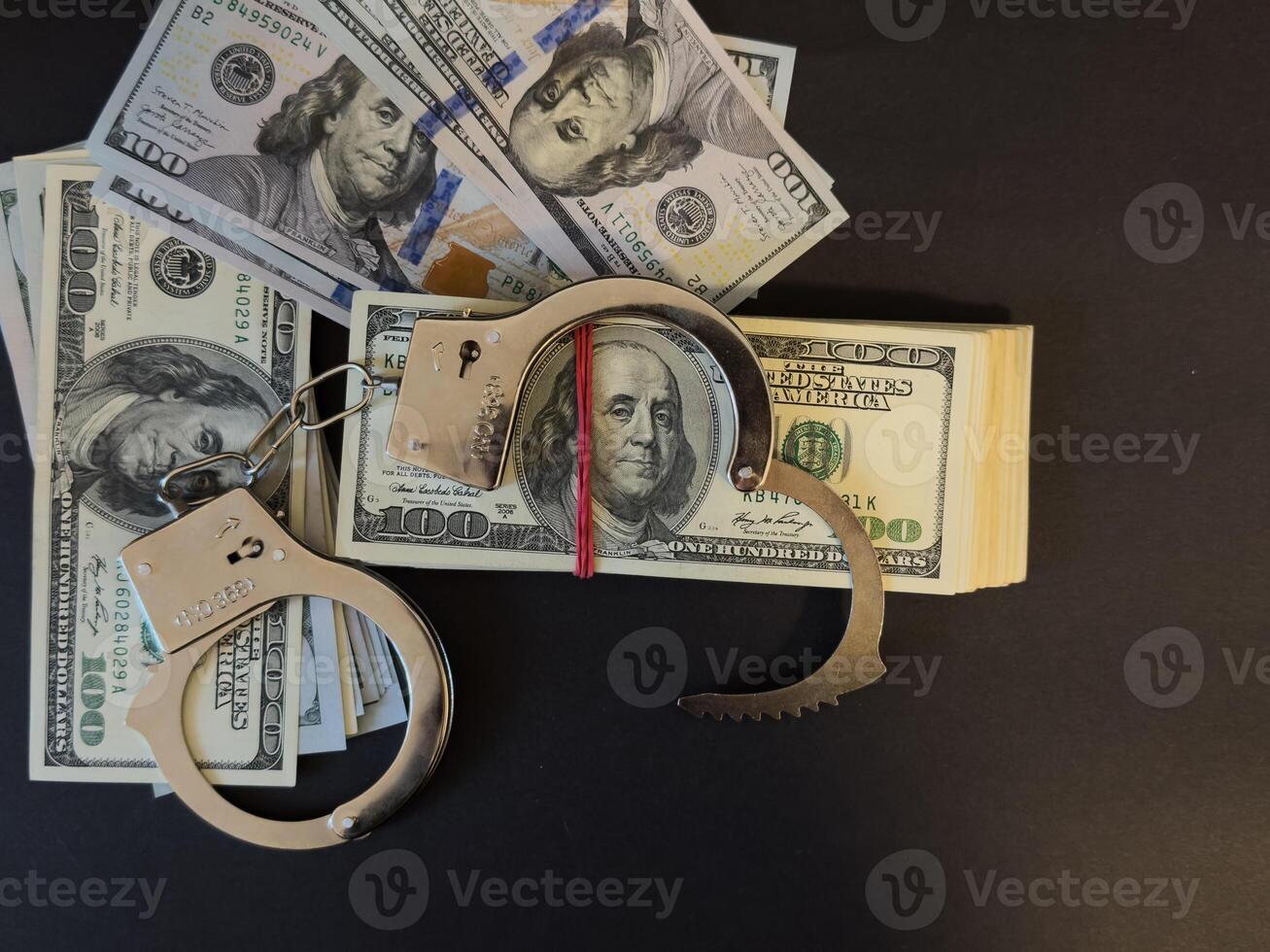 Handcuffs on 100 Bills on Concrete Floor for Crime photo