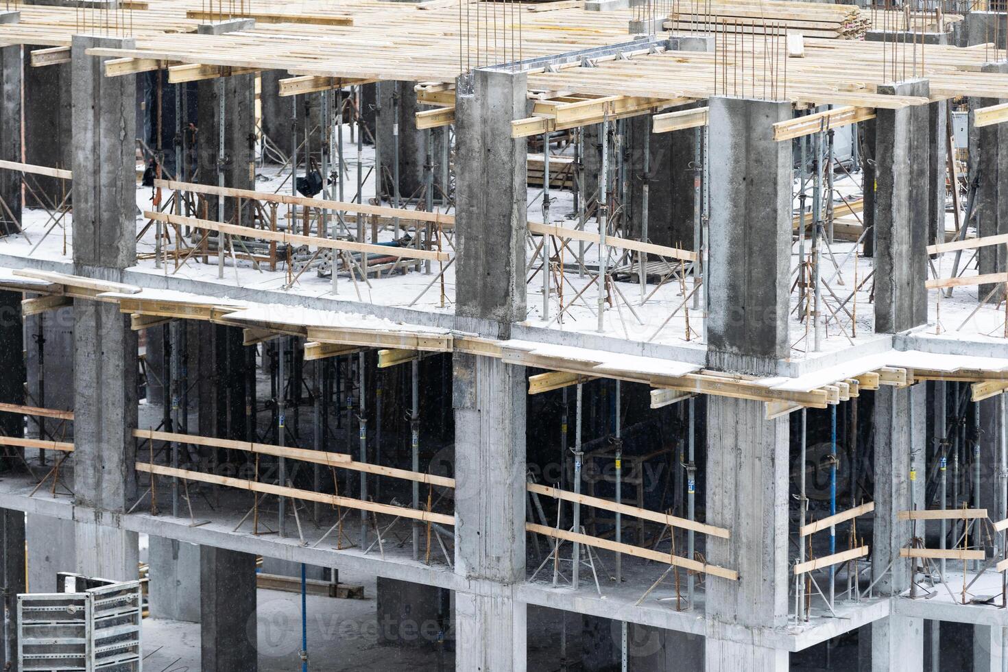 concreting work. construction site worker during concrete pouring into formwork at building area with skip photo