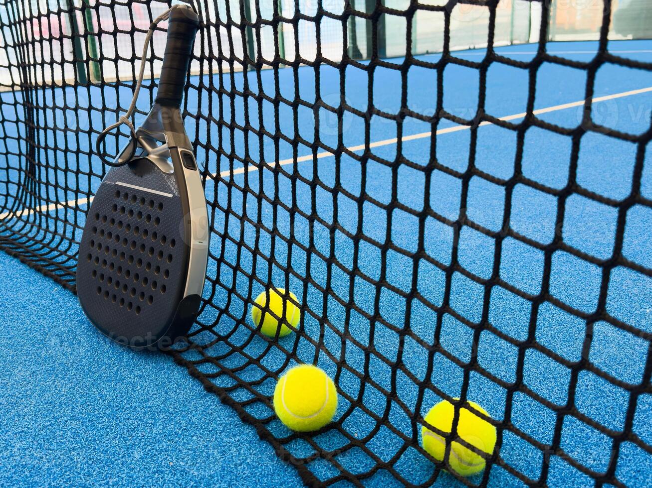 r sport concept with padel tennis ball on white line on padel tennis court blue color. Flat lay, top view, copy space, close up. photo