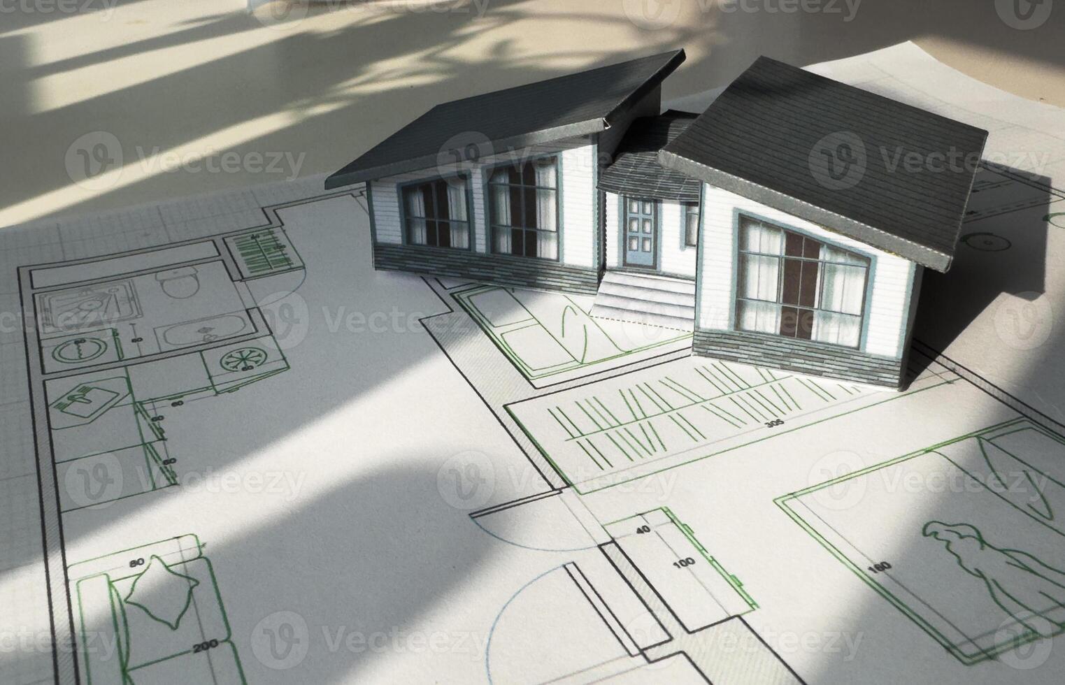 Construction blueprints concept. Residential building drawings and architectural house model on an office desk, copy space, template. Architect engineer workplace photo
