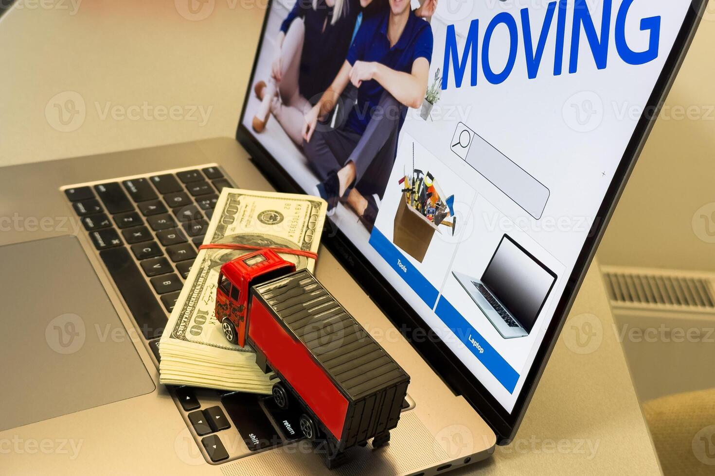 Logistics, supply chain and delivery service concept . Trailer truck moves boxes of goods on a laptop computer, depicts sending products ordered on ecommerce platform photo