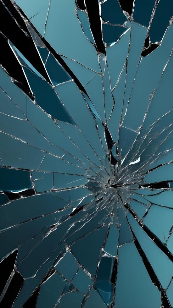 A detailed image of cracked glass with sharp, radiating fracture lines. photo