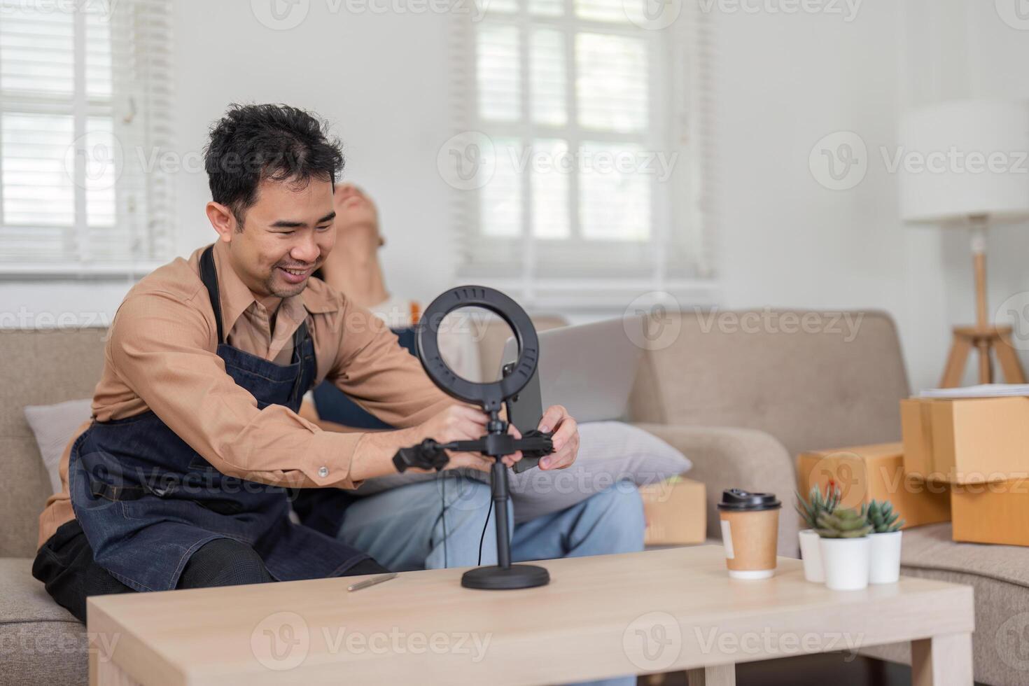 Online seller setting up a ring light for content creation at home. photo