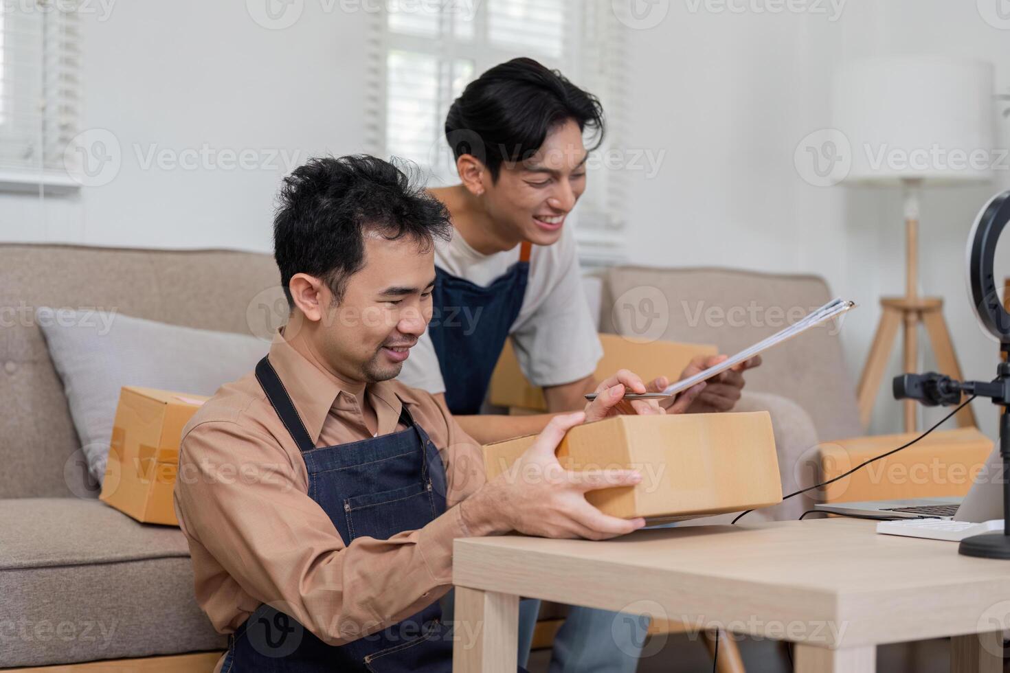 Two online sellers preparing packages for shipment, showcasing teamwork and entrepreneurship. photo