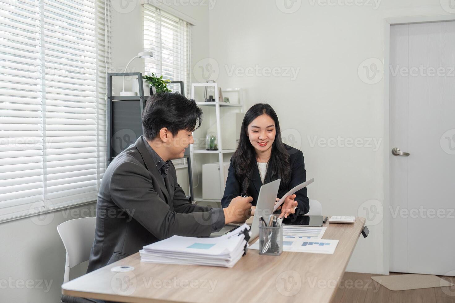 Diverse business professionals collaborating on financial reports and analysis in a modern office. photo
