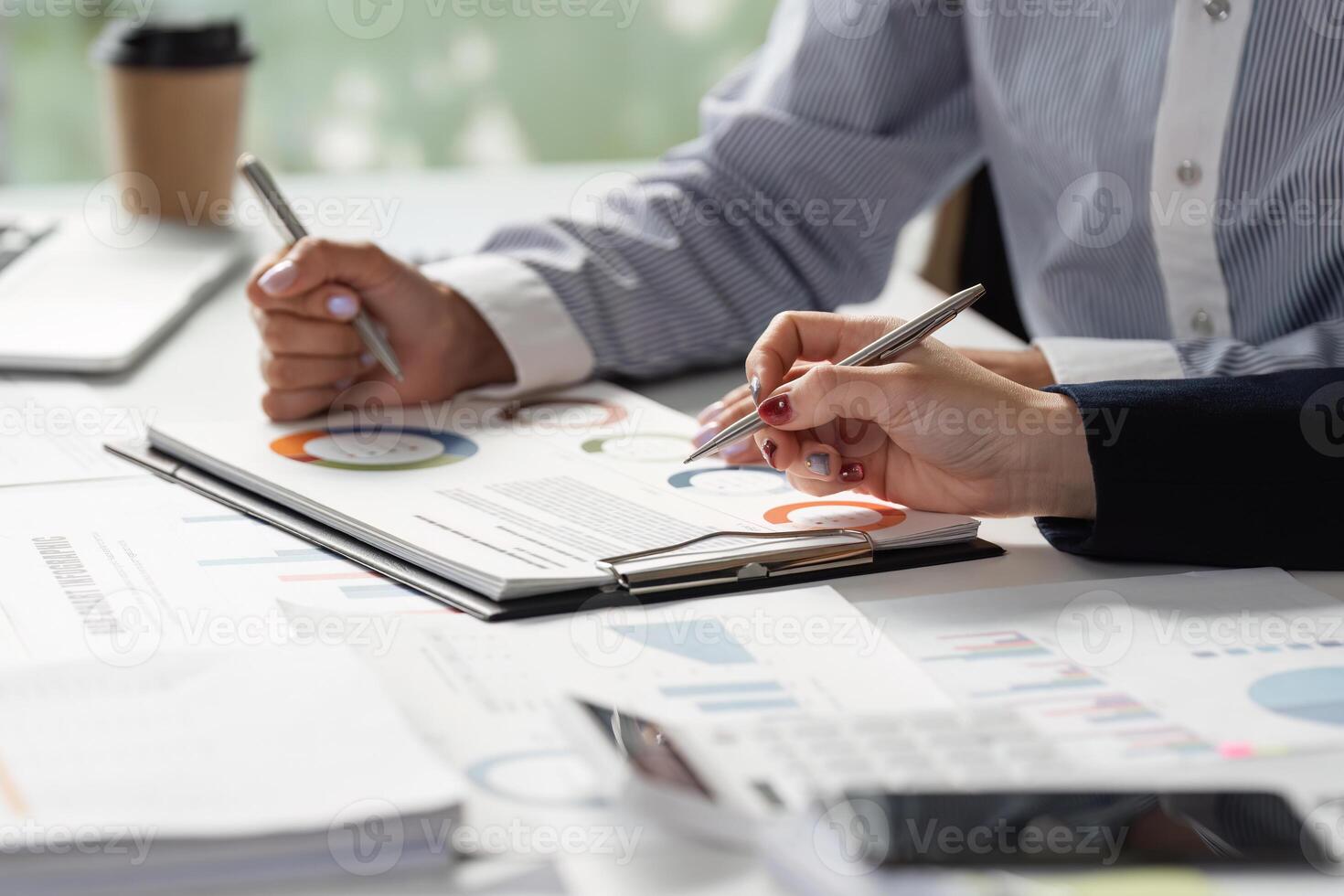 Team members reviewing financial data and strategies, using charts and documents for effective planning. photo