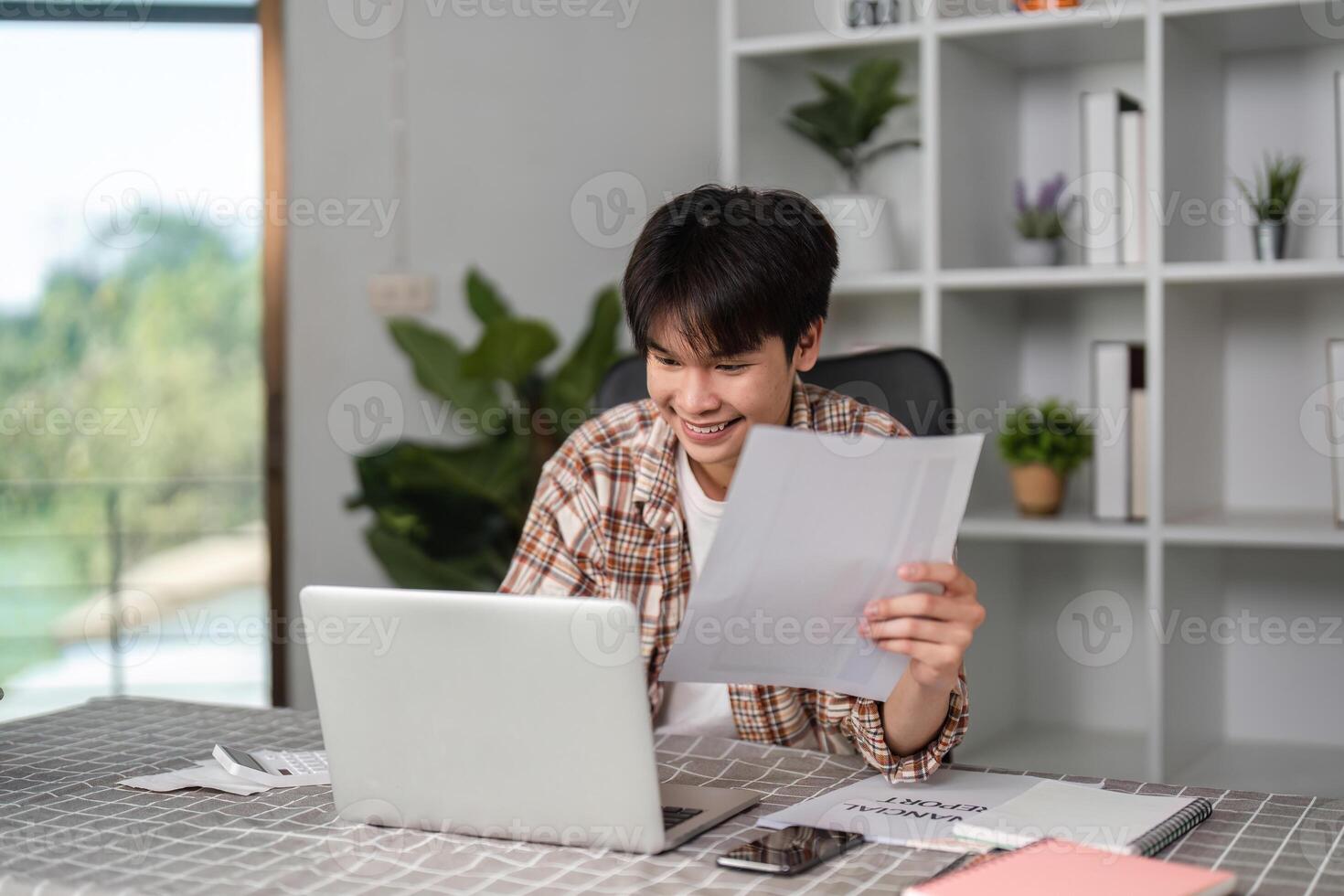 Young financial expert reviewing budget documents with a smile in a contemporary workspace photo
