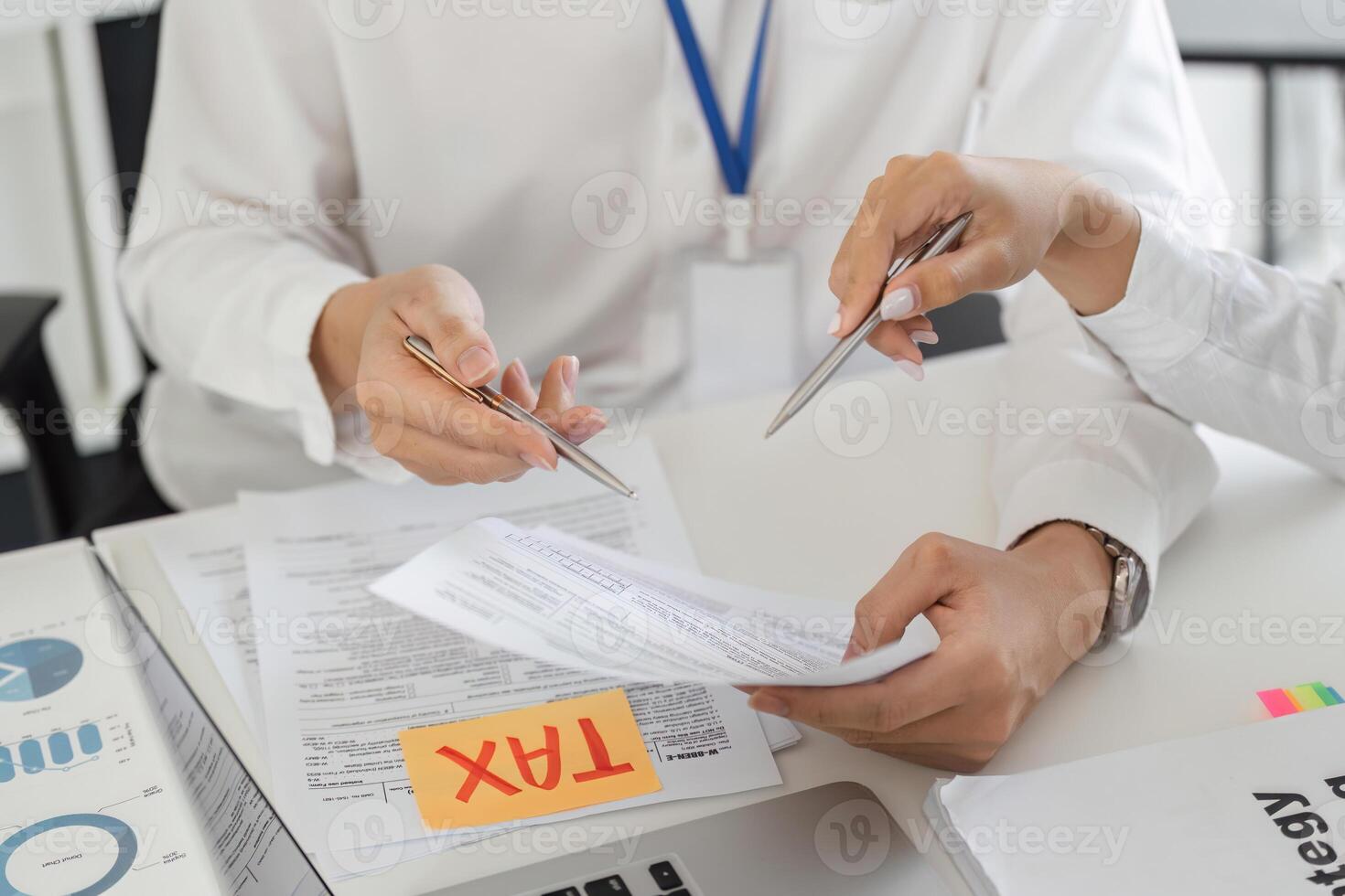 Team discussing tax forms and financial strategies in an office photo