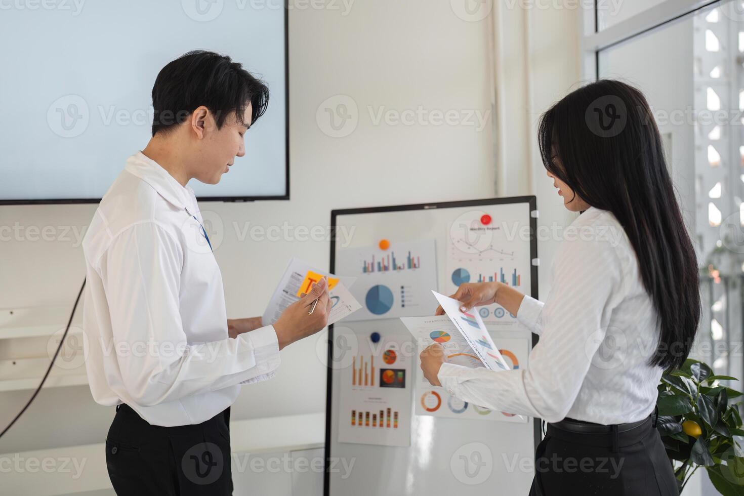 Colleagues analyzing financial reports and tax data in a collaborative workspace photo