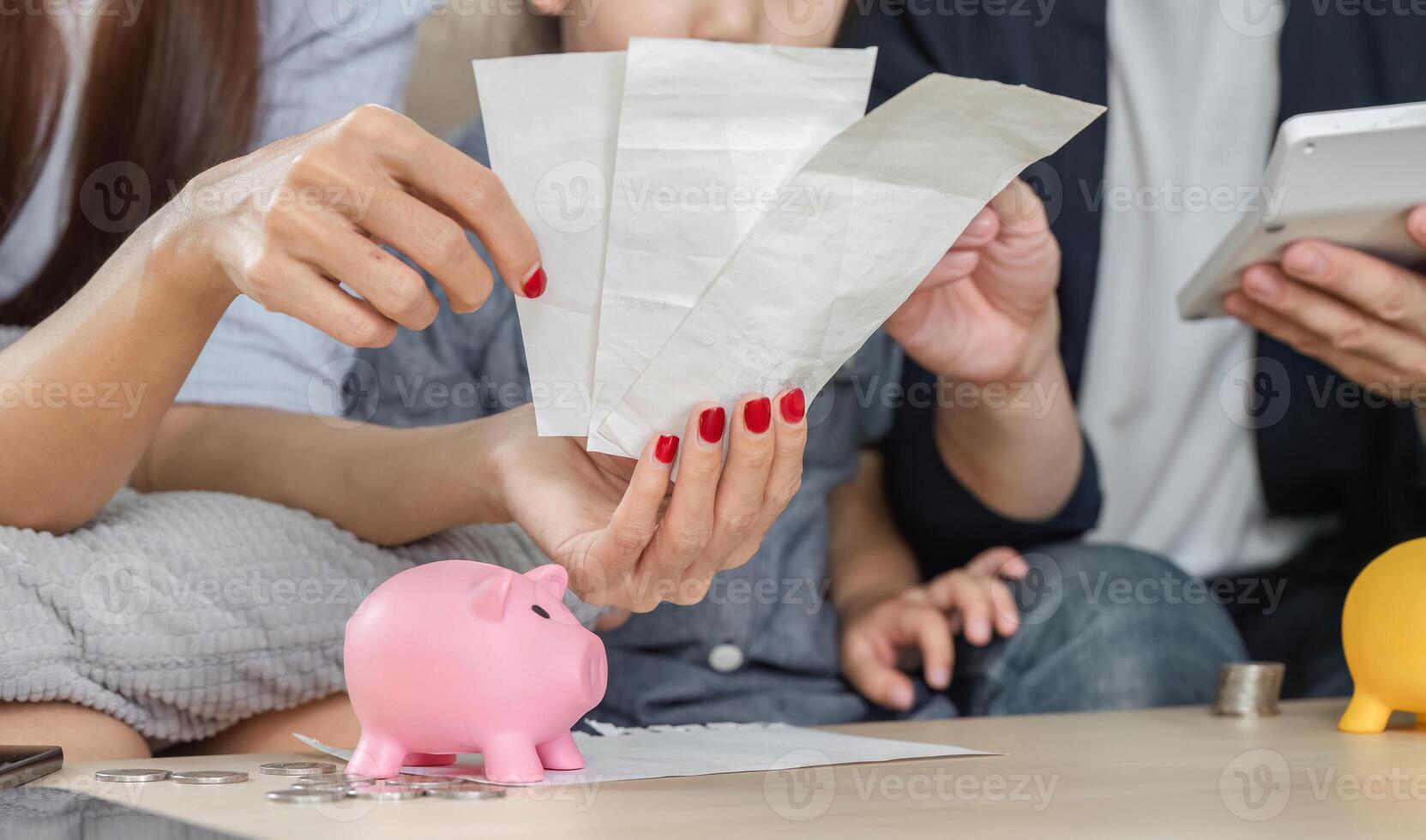 Family analyzing bills together, focusing on savings and expenses photo