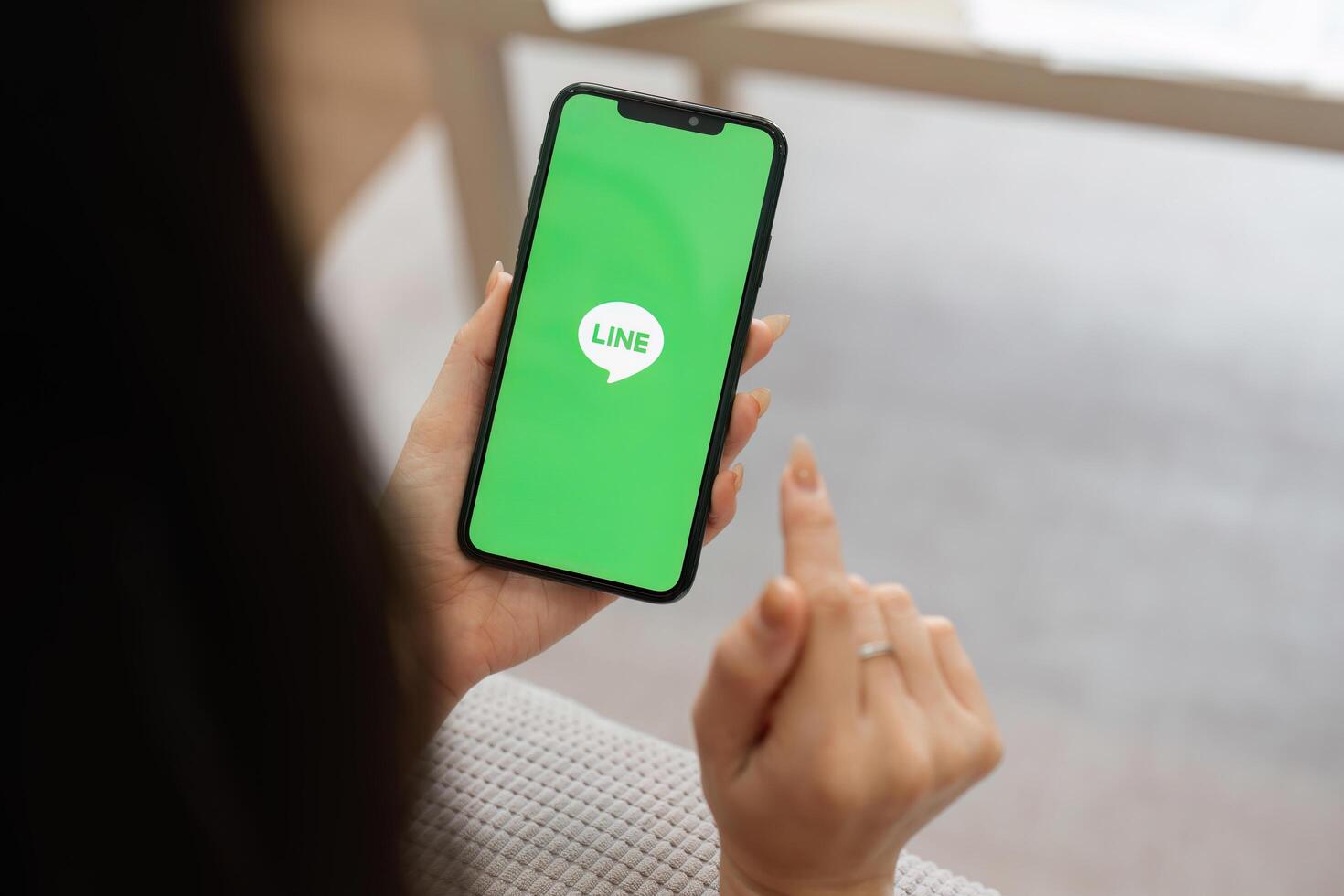 CHIANG MAI, THAILAND - FEB 27 2025. Individual using a smartphone with the LINE app open, showcasing modern communication. photo