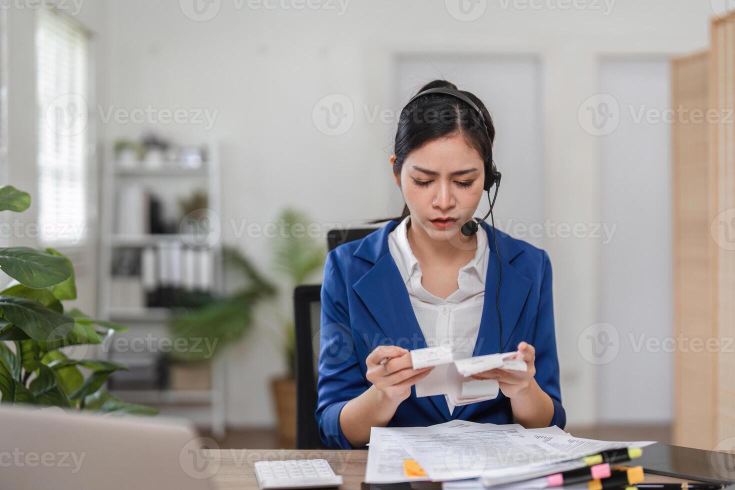 Dedicated accountant reviewing financial documents while on a call, emphasizing attention to detail in tax preparation. photo