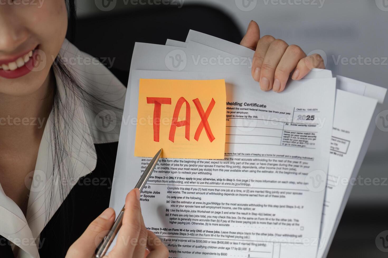 Accountant detailing tax documents, emphasizing important financial aspects. photo