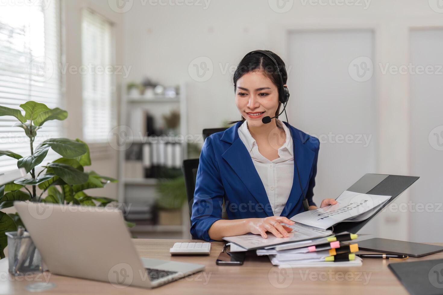 Smiling accountant reviewing financial documents and engaging with clients in a bright workspace. photo
