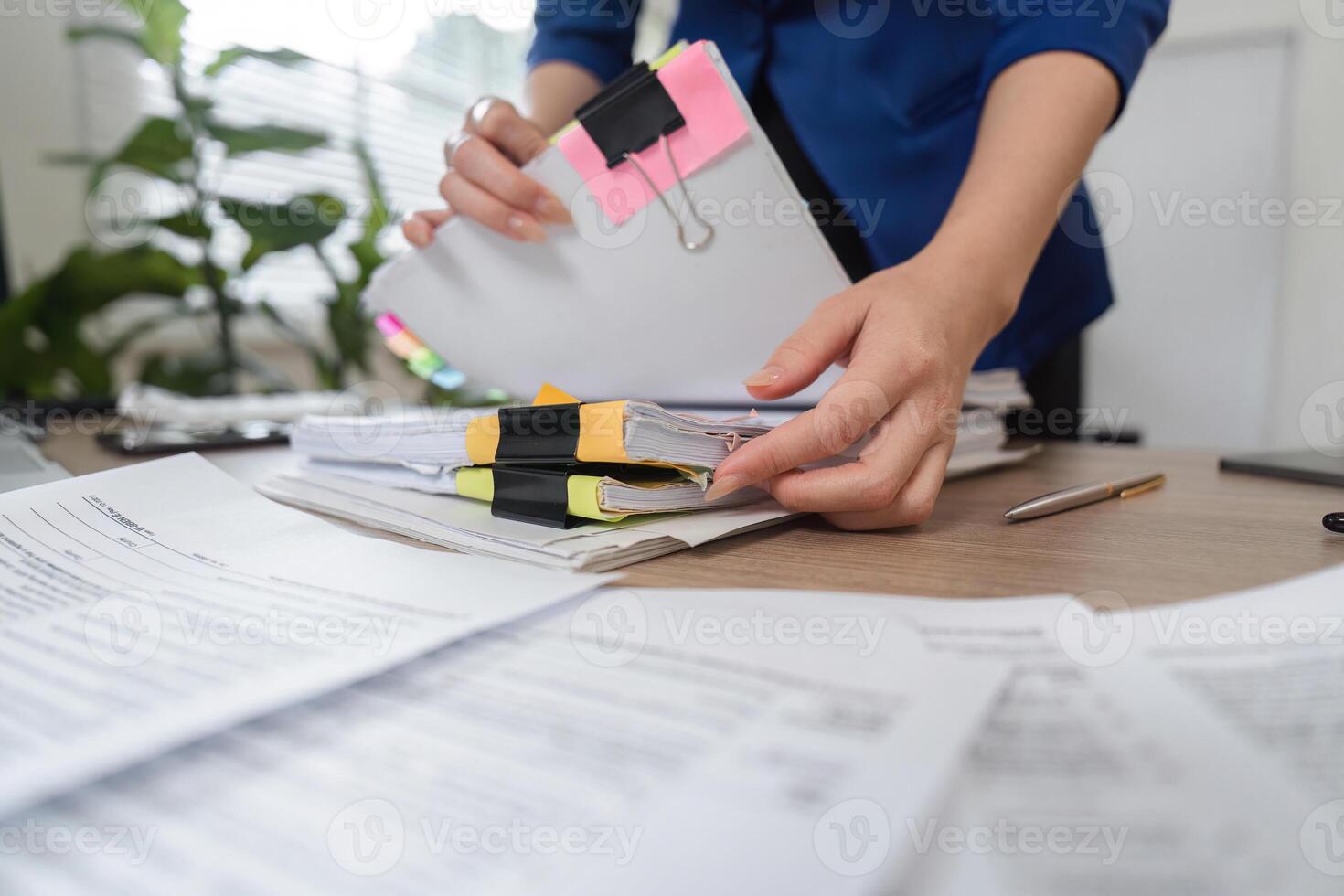 Accountant handling organized financial paperwork and reports photo