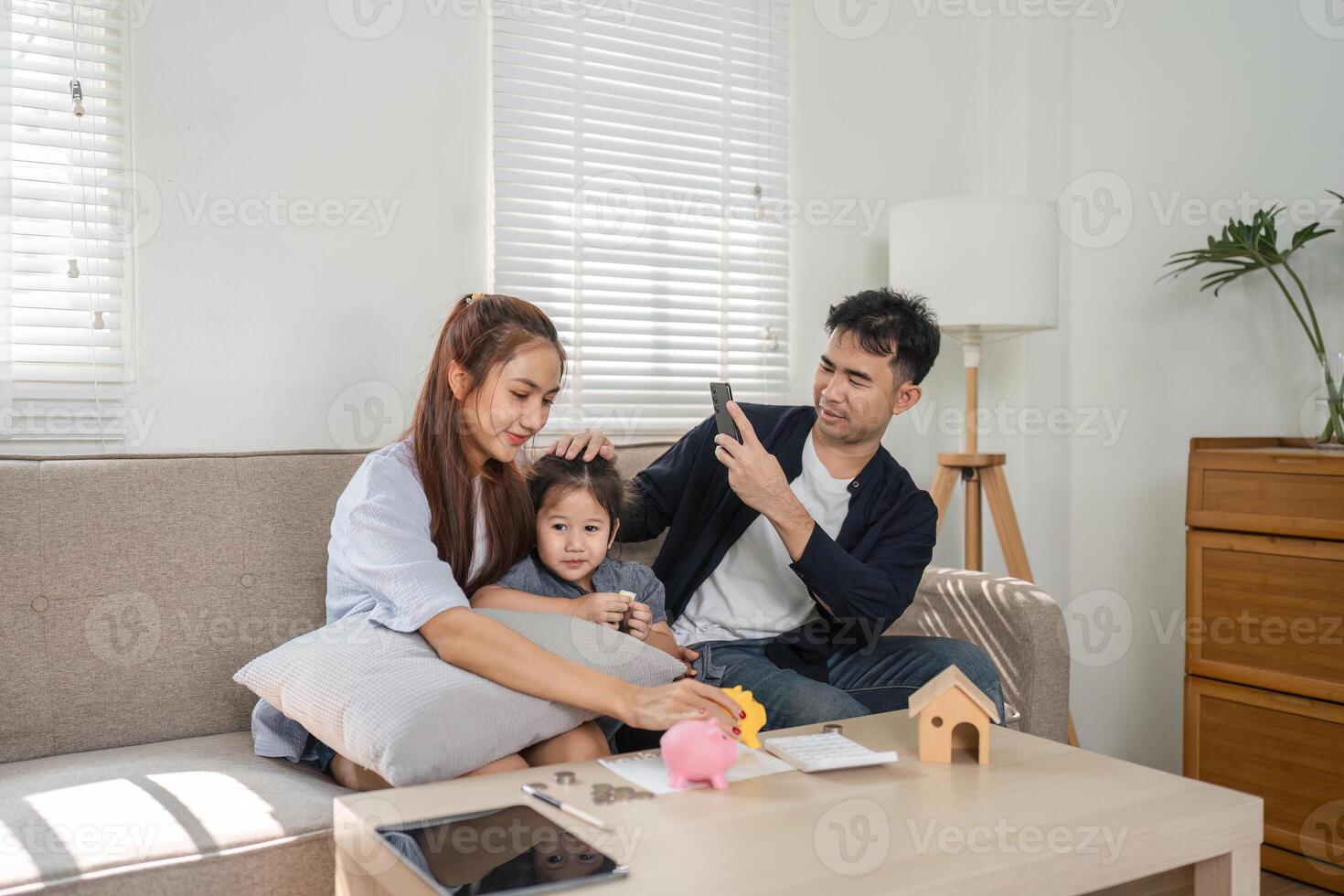 Family engaging in financial planning at home, teaching children about saving money. photo