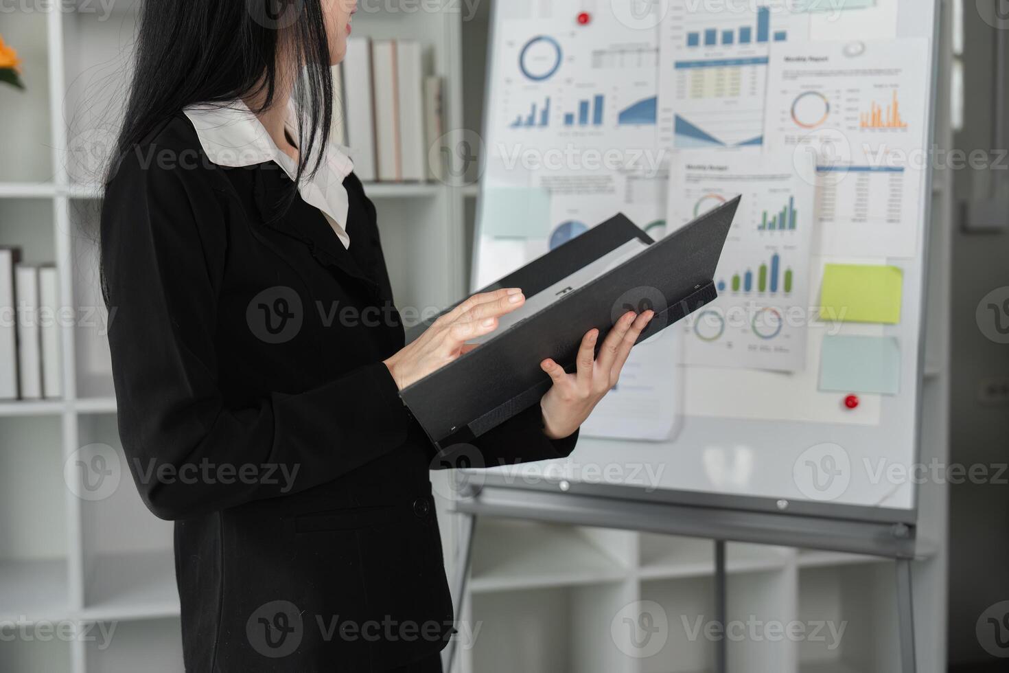 Businesswoman analyzing financial data and reports in a modern office setting. photo