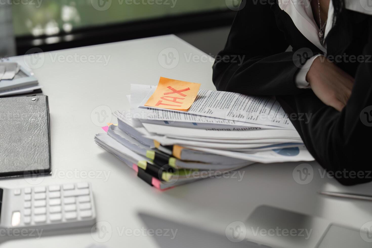 Tax documents and calculator on a desk, highlighting financial responsibilities. photo