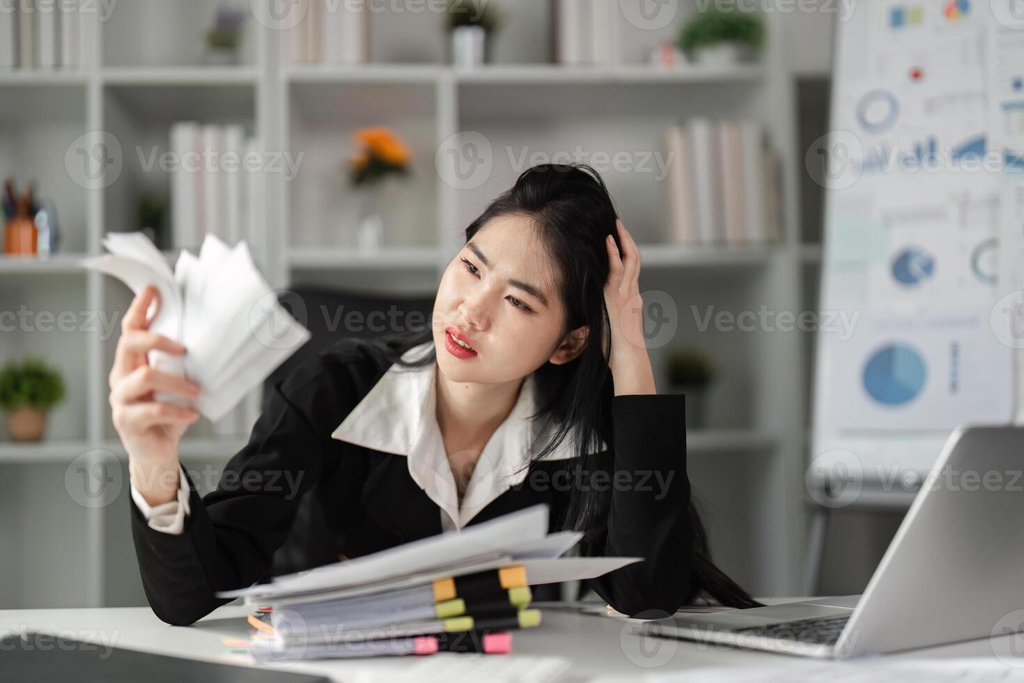 Businesswoman deeply focused on tax documents, navigating the complexities of financial reporting. photo